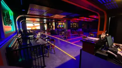 a room with a bar with purple and green lights at The Zen Park Coimbatore in Coimbatore