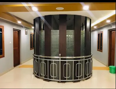 a room with a large shower in a building at MP RESIDANCY in Perintalmanna
