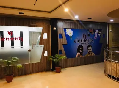 a lobby with signs on the wall and plants at MP RESIDANCY in Perintalmanna