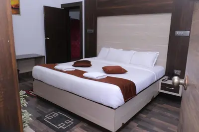 a bedroom with a bed with white sheets and pillows at Cloud Nine Kothagiri By Lexstays in Kotagiri