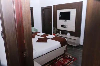 a bedroom with a bed and a television in it at Cloud Nine Kothagiri By Lexstays in Kotagiri