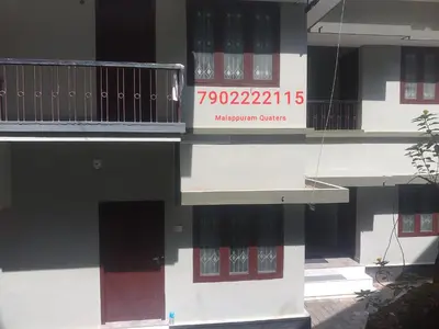 a building with a sign on the side of it at Malapuram quarters in Malappuram