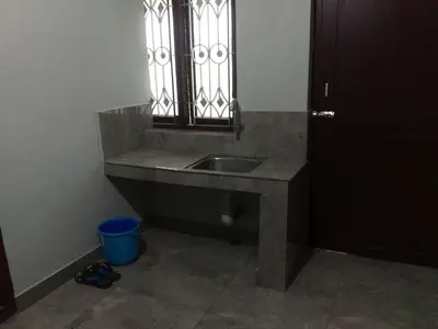 a bathroom with a sink and a window at Malapuram quarters in Malappuram