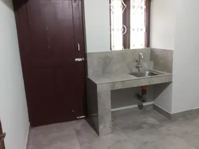 a bathroom with a sink and a mirror at Malapuram quarters in Malappuram
