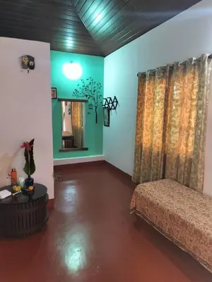 a bedroom with a bed and a mirror at Madan Homestay in Napoklu