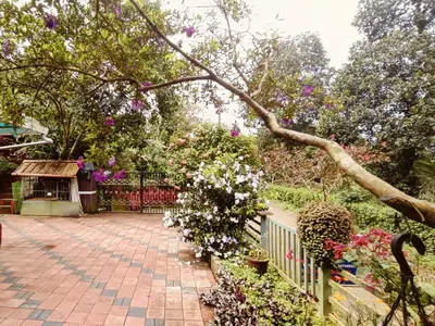 a garden with flowers and a fence at Divine View Holyday Home (Homestay) in Kalpetta