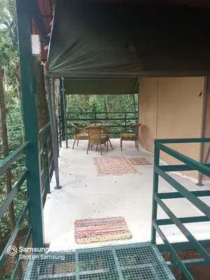 a tent with tables and chairs on a patio at Devi Villa - Plantation Retreat and Forest Getaway in Kutta
