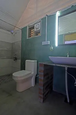 a bathroom with a white toilet and a sink at Devi Villa - Plantation Retreat and Forest Getaway in Kutta