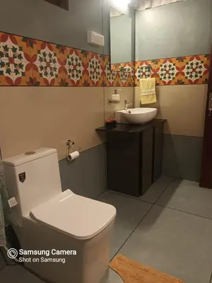 a bathroom with a white toilet and a sink at Devi Villa - Plantation Retreat and Forest Getaway in Kutta