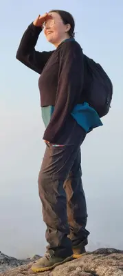 a woman standing on top of a rock at Crossroads Hostel 1957 in Wayanad