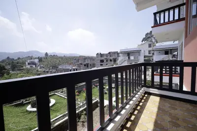 a balcony with a view of a city at PURPLE ORCHID BY XACRO XPERIENCES in Kodaikānāl