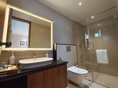 a bathroom with a sink and a toilet and a shower at Stays By MindEscapes in Ketti