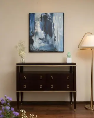 a black dresser with a painting on the wall at Stays By MindEscapes in Ketti