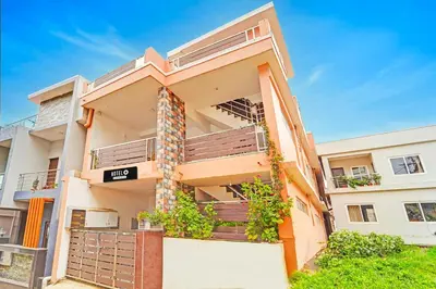 an apartment building with balconies and plants at Super Hotel O Vijaynagar Road Formerly Anmol Peace Stay in Ooty