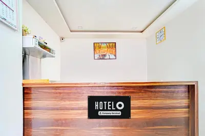 a hotel room with a hotel sign on the wall at Super Hotel O Vijaynagar Road Formerly Anmol Peace Stay in Ooty