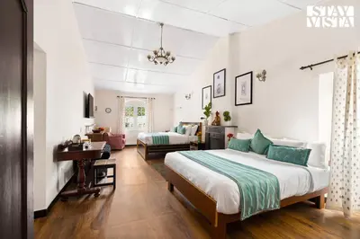 a bedroom with a bed and a living room at StayVista at The Alcove with Breakfast & BBQ Grill in Ooty