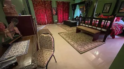 an aerial view of a bedroom with a bed and rugs at Habba Kadal Kashmiri Heritage Hotel & Hub in Coonoor