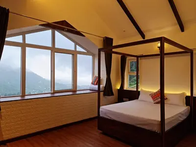 a bedroom with a canopy bed and a large window at Sky Sketch in Kodaikānāl