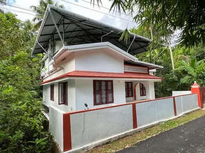 a small house with a red roof at 3 bedroom country home with a lush full backyard in Trichūr