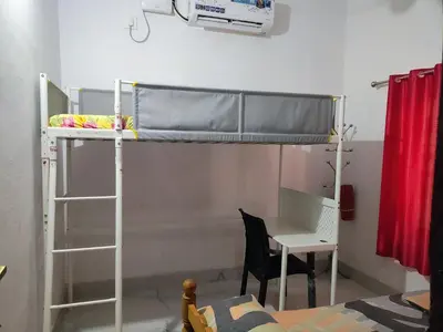 a dorm room with a bunk bed and a desk at 3 bedroom country home with a lush full backyard in Trichūr
