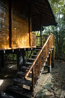 a set of stairs leading to a wooden building at Uravu Bamboo Grove Resort in Wayanad