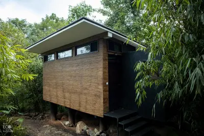 a tiny house in the middle of a forest at Uravu Bamboo Grove Resort in Wayanad