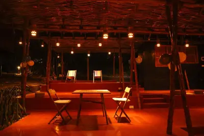 a stage with chairs and a table in front of a stage at Uravu Bamboo Grove Resort in Wayanad
