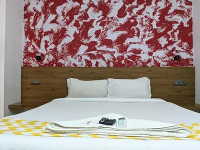 a bedroom with a bed with a towel on it at Cherai Blue View Beach Resort in Cochin