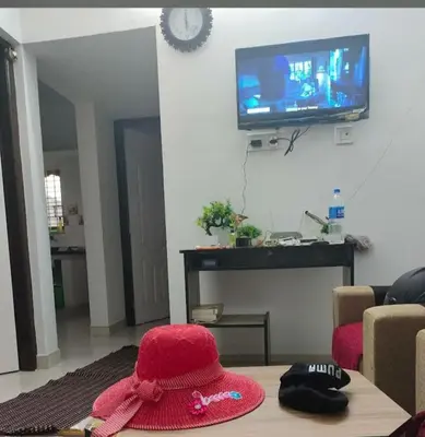 a red hat sitting on a table in a living room at 7coloursholidays in Kanthalloor