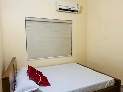 a bedroom with a window with a window blind at Fathima Apartments in Iritti