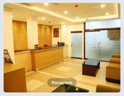 a living room with a reception desk and a couch at Hotel Sasthapuri in Kozhikode