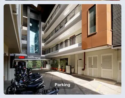 a row of motorcycles parked outside of a building at Hotel Sasthapuri in Kozhikode