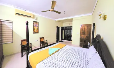 a bedroom with a bed and a ceiling fan at KRISHNAGIRI homes in Guruvāyūr