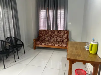 a living room with a couch and a table and chairs at HOLLYWOOD Rooms in Sultan Bathery