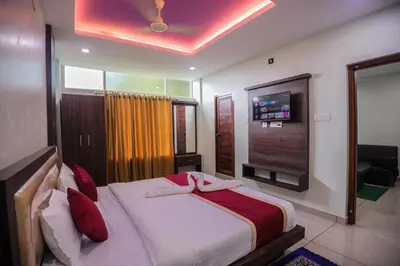 a bedroom with a large bed with a tv on the wall at zanbaq residency in Vythiri