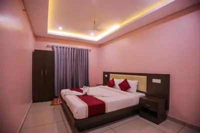 a bedroom with a bed in a room with pink walls at zanbaq residency in Vythiri