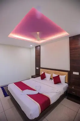 a bedroom with a large bed with a pink ceiling at zanbaq residency in Vythiri