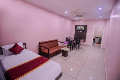 a bedroom with a bed and a couch and a table at zanbaq residency in Vythiri