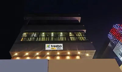 a tall building with a sign on the side of it at Itsy Hotels Sapphire Residency in Manjeri