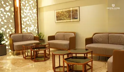 a waiting room with chairs and tables in a hospital at Crystal Suites in Badagara