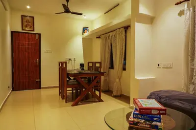a room with a desk and a table in a room at VanaJyotsna Forest Home in Marayoor