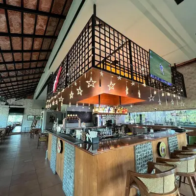 a restaurant with a bar with chairs and lights at PEARL MAHE in Mahe