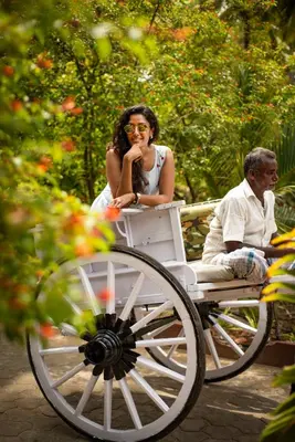 a man and a woman sitting in a carriage at Ibex River Resort, Pollachi in Coimbatore