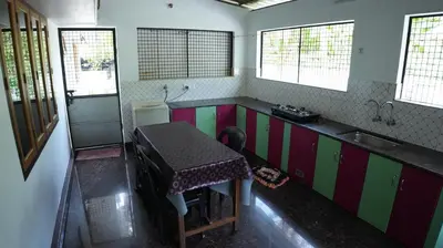 a small kitchen with a table and a sink at Thas apartment near rajagiri hospital in Alwaye