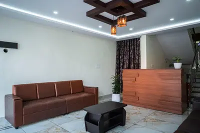 a living room with a couch and a table at Aldora Airport Residency in Nedumbassery