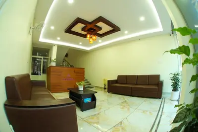 a living room with a couch and a ceiling at Aldora Airport Residency in Nedumbassery