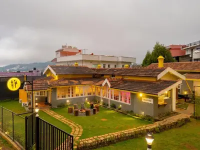 a house with a garden in front of it at The Hosteller Ooty in Ooty