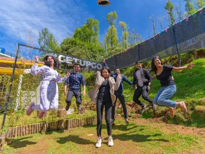 a group of people jumping in the air at The Hosteller Ooty in Ooty