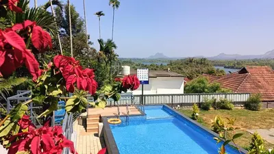 a view of a swimming pool from a house at Karapuzha Water Scapes Wayanad in Wayanad