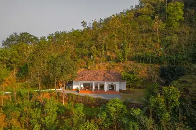 a house in the middle of a hill at La Grove 2BHK with Stunning View - Kannur in Wayanad
